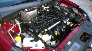 The 2009 Ford Focus SES coupe (North America) engine bay. Its design is “done” in the sense that it’s available to consumers.
